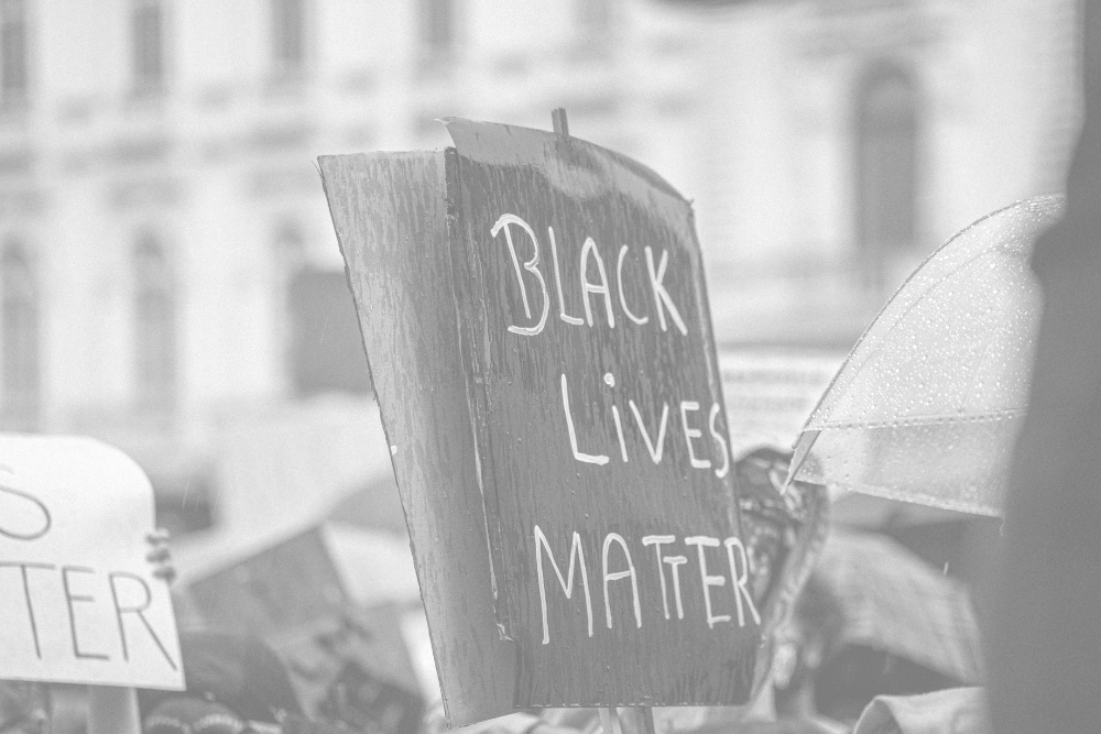 Image of a sign at a protest reading, 'Black Lives Matter'
